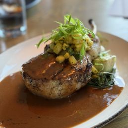 Urban Hill signature dishes Pork Chop, Skillet Rolls, Pacifico Striped Bass, Crab Ravioli, Coal Roasted Beets, Bison Ribeye Steak